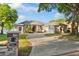Charming home featuring a well-manicured lawn, a brick driveway, and mature trees in a lush landscape at 248 Lake Tennessee Dr, Auburndale, FL 33823