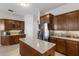 Beautiful kitchen with stainless steel appliances, island, granite countertops, and wood cabinets at 248 Lake Tennessee Dr, Auburndale, FL 33823
