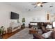 Inviting living room features a comfortable leather sectional, gray rug, and a large TV at 248 Lake Tennessee Dr, Auburndale, FL 33823