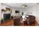 Cozy living room with hardwood floors, a fireplace, a flat-screen TV, and stylish decor at 248 Lake Tennessee Dr, Auburndale, FL 33823
