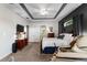 Spacious main bedroom with tray ceiling, en-suite bathroom, and comfortable seating area at 248 Lake Tennessee Dr, Auburndale, FL 33823