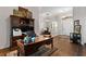 Home office features a wooden desk, built-in shelves, and an open view of the entryway and dining room at 248 Lake Tennessee Dr, Auburndale, FL 33823