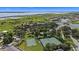 Aerial view of a community with a lake, tennis courts, and basketball court at 3601 Weatherfield Dr, Kissimmee, FL 34746