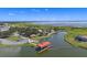 Aerial view of a community with a lake, boat dock, and clubhouse at 3601 Weatherfield Dr, Kissimmee, FL 34746