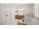 Bathroom featuring double sinks, a soaking tub with marble tile, and a walk-in shower at 3601 Weatherfield Dr, Kissimmee, FL 34746