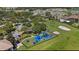 Aerial view of a community playground with a picnic area, and volleyball court at 3601 Weatherfield Dr, Kissimmee, FL 34746
