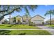 Inviting single-story home with a well-manicured lawn, a tile roof, and a two-car garage at 3601 Weatherfield Dr, Kissimmee, FL 34746