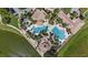 Aerial view of a resort-style pool with multiple pools, palm trees, and lounge chairs at 3601 Weatherfield Dr, Kissimmee, FL 34746