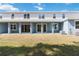 The backyard view of the home features a patio and a well manicured lawn at 5244 Luisa Ct, St Cloud, FL 34771