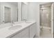 Modern bathroom featuring double vanity with stone countertop and tiled shower stall at 5244 Luisa Ct, St Cloud, FL 34771