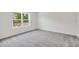 Bright bedroom with gray carpet, one window, and white walls and trim at 5244 Luisa Ct, St Cloud, FL 34771