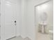Inviting entryway with neutral tones, a white front door, and a convenient powder room at 5244 Luisa Ct, St Cloud, FL 34771