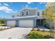 A townhome showcasing a driveway, front lawn, and inviting facade under a clear blue sky at 5244 Luisa Ct, St Cloud, FL 34771