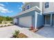 A townhome showcasing a driveway, front lawn, and inviting facade under a clear blue sky at 5244 Luisa Ct, St Cloud, FL 34771