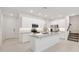 A bright kitchen features white cabinets, stainless steel appliances, and granite countertops at 5244 Luisa Ct, St Cloud, FL 34771