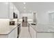 Bright kitchen with stainless steel appliances, granite countertops, and ample white cabinets at 5244 Luisa Ct, St Cloud, FL 34771