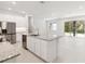 Open-concept kitchen with a large island, stainless steel appliances, and sleek white cabinetry at 5244 Luisa Ct, St Cloud, FL 34771
