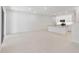 Bright, open-concept living room flowing into a kitchen area with white cabinetry and tiled floor at 5244 Luisa Ct, St Cloud, FL 34771