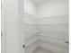 Walk-in pantry with multiple tiers of wire shelving for ample storage at 5244 Luisa Ct, St Cloud, FL 34771
