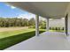 The back porch with beautiful views of the green lawn and the treeline at 9432 Emerald Berry Dr, Winter Garden, FL 34787