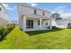 The back of the home features a covered porch and a well-maintained lawn at 9432 Emerald Berry Dr, Winter Garden, FL 34787