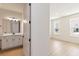 Bathroom leads to a bedroom featuring a modern vanity and ample natural light at 9432 Emerald Berry Dr, Winter Garden, FL 34787