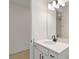 This bathroom features a sleek vanity with a modern faucet, mirror, and contemporary lighting at 9432 Emerald Berry Dr, Winter Garden, FL 34787