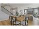 Dining area with a wood table, gray cushioned chairs and hardwood flooring at 9432 Emerald Berry Dr, Winter Garden, FL 34787