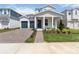 Charming two-story home featuring a two-car garage and inviting front porch with manicured landscaping at 9432 Emerald Berry Dr, Winter Garden, FL 34787