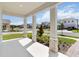 Inviting front porch showcases stylish columns, lush landscaping, and a glimpse of the neighborhood at 9432 Emerald Berry Dr, Winter Garden, FL 34787