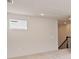 Bright room featuring a window and staircase with a black railing at 9432 Emerald Berry Dr, Winter Garden, FL 34787