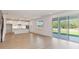 Open living space flows to the modern kitchen and covered patio via sliding glass doors at 9432 Emerald Berry Dr, Winter Garden, FL 34787
