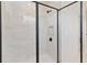 Walk-in shower with glass door showcases marble tile and modern fixtures at 9432 Emerald Berry Dr, Winter Garden, FL 34787