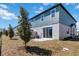 A well-maintained backyard features a sliding glass door, a small patio, and neatly arranged landscaping at 1092 Desert Candle Dr, Ocoee, FL 34761