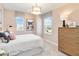 Charming bedroom with patterned curtains, two windows, light pink walls, and decorative art at 1104 Desert Candle Dr, Ocoee, FL 34761