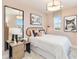 Comfortable bedroom featuring modern decor, light pink walls, patterned curtains, and a framed picture at 1104 Desert Candle Dr, Ocoee, FL 34761