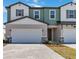 Inviting two-story townhome showcasing a two-car garage and well-maintained landscaping at 1104 Desert Candle Dr, Ocoee, FL 34761