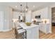 Well-equipped modern kitchen with stainless steel appliances and a convenient island with seating at 1104 Desert Candle Dr, Ocoee, FL 34761