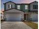 Inviting townhomes with neutral colors, two car garages, and brick paver driveways at 2465 Magnolia Reserve Rd, Ocoee, FL 34761