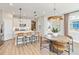 Modern kitchen with white cabinetry, stainless steel appliances, hardwood floors and an island with barstool seating at 2473 Magnolia Reserve Rd, Ocoee, FL 34761