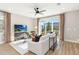 A bright and spacious living room with plush sofa, large window, and modern entertainment center at 2473 Magnolia Reserve Rd, Ocoee, FL 34761