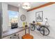 Home office featuring unique bicycle decor, wooden desk, and bright window view at 2473 Magnolia Reserve Rd, Ocoee, FL 34761