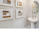 Bright powder room with modern vanity and framed abstract artwork at 2473 Magnolia Reserve Rd, Ocoee, FL 34761