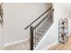 Carpeted staircase with dark wood railing and iron balusters at 2473 Magnolia Reserve Rd, Ocoee, FL 34761