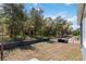 Expansive backyard bordered by lush trees, offering privacy and a serene outdoor space at 5228 Luisa Ct, St Cloud, FL 34771