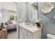 Bright bathroom with white cabinets, quartz countertop, and an ensuite bedroom at 5228 Luisa Ct, St Cloud, FL 34771
