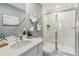 Bright bathroom with white cabinets, quartz countertop, and a glass-enclosed shower at 5228 Luisa Ct, St Cloud, FL 34771