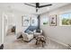 Bright bedroom with modern ceiling fan, unique side table, and neutral décor creates a calming and inviting space at 5228 Luisa Ct, St Cloud, FL 34771