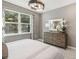 Bright bedroom features a large window, dresser, and neutral decor at 5228 Luisa Ct, St Cloud, FL 34771
