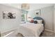 Stylish bedroom featuring a plush bed, modern light fixture, and eye-catching artwork at 5228 Luisa Ct, St Cloud, FL 34771